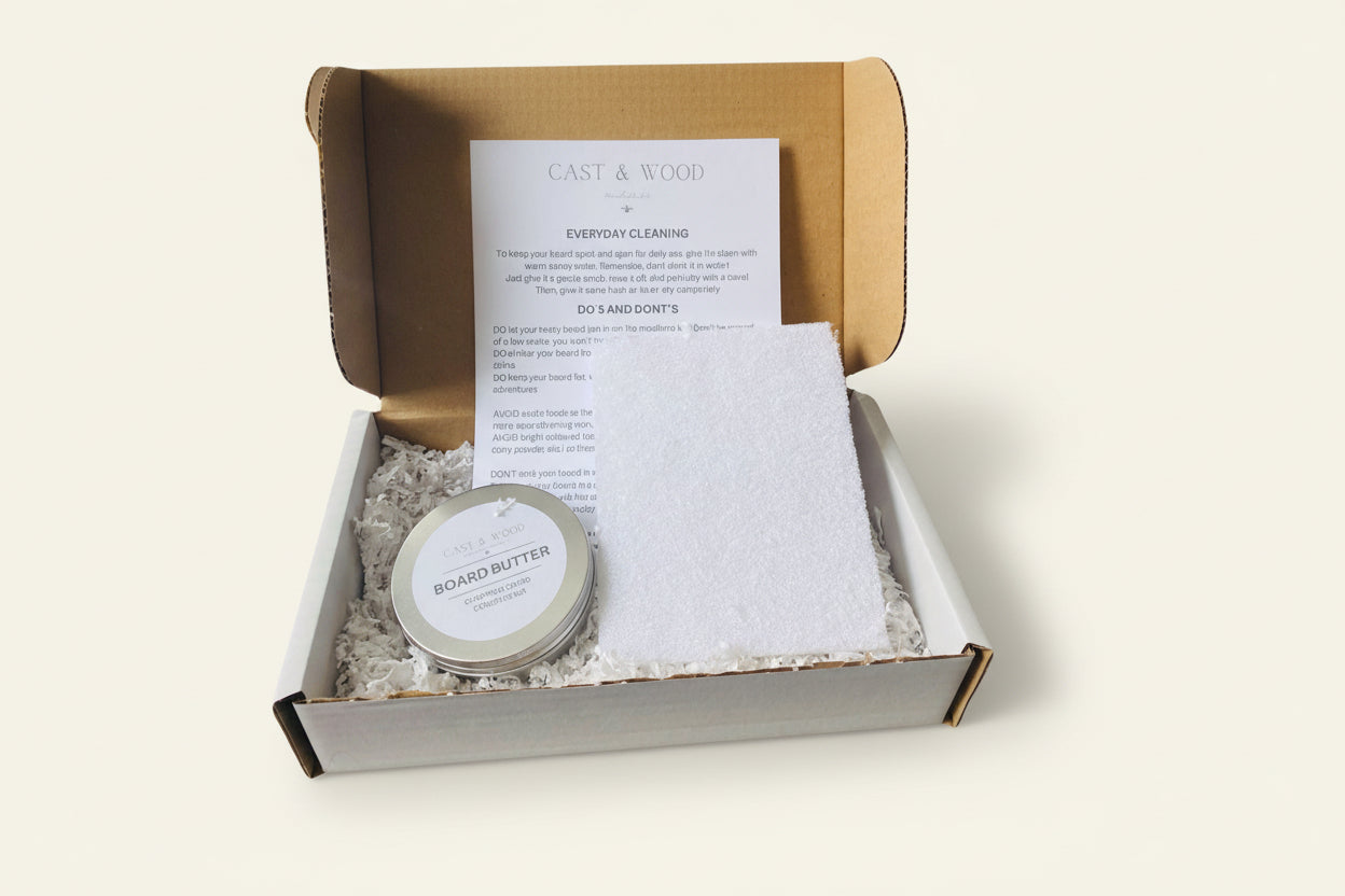 Chopping Board Conditioning Kit with Board Butter tin, cloth, and instruction sheet in a cardboard box.