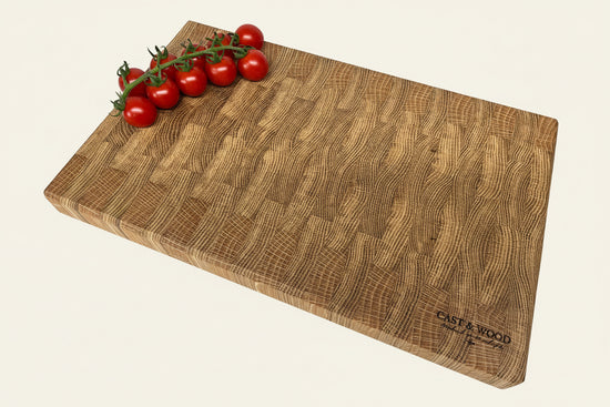 Large end grain chopping board with a textured surface and cherry tomatoes, showcasing its natural wood finish.