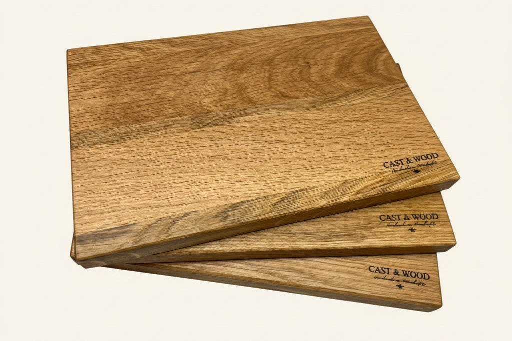 Medium-sized solid oak chopping board with a smooth surface and natural wood grain pattern, featuring Cast & Wood branding.