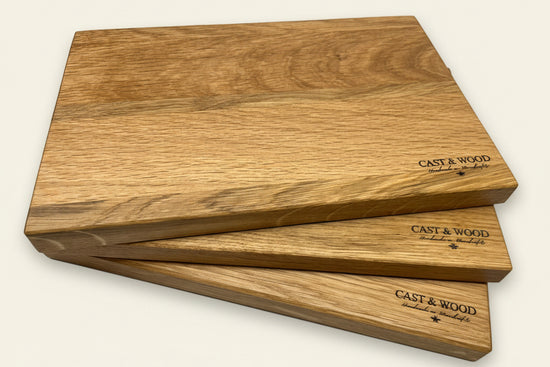 Three wooden chopping boards with smooth surfaces and rounded edges, featuring the CAST & WOOD logo.