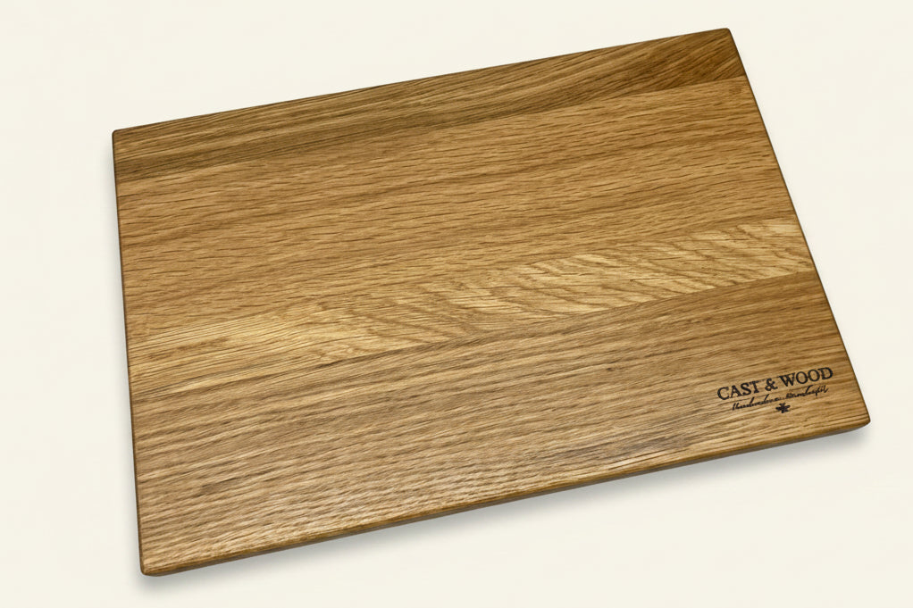 Rectangular oak chopping board with a smooth surface and natural wood grain pattern, featuring cast & wood logo in one corner.