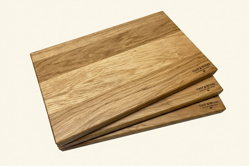 Large Piccadilly chopping boards stacked, showcasing smooth surfaces and unique grain patterns.
