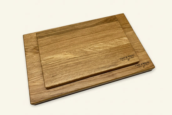 Two wooden chopping boards of different sizes with smooth surfaces and rounded edges, featuring a natural wood finish.