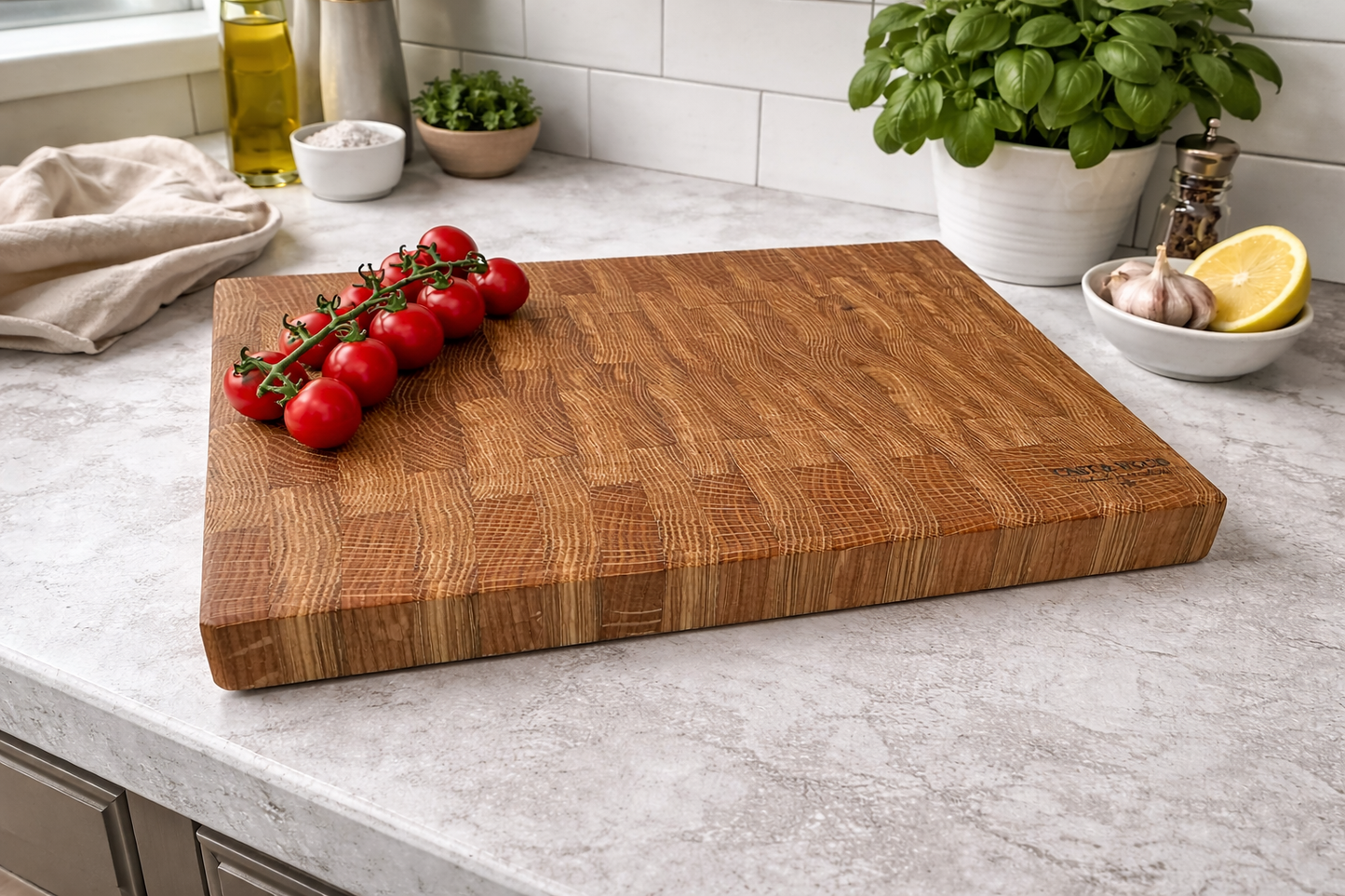 Large end grain chopping board with a textured surface, fresh tomatoes, and kitchen items in the background.
